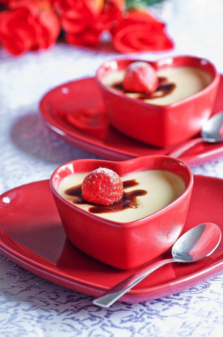 Vanilla panna cotta with strawberries in heart-shaped dishes