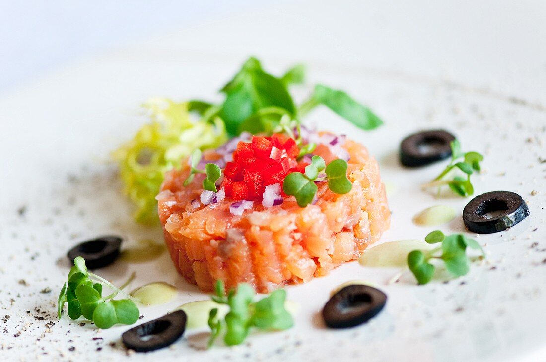 Smoked salmon tartar with cress, black olives and red pepper