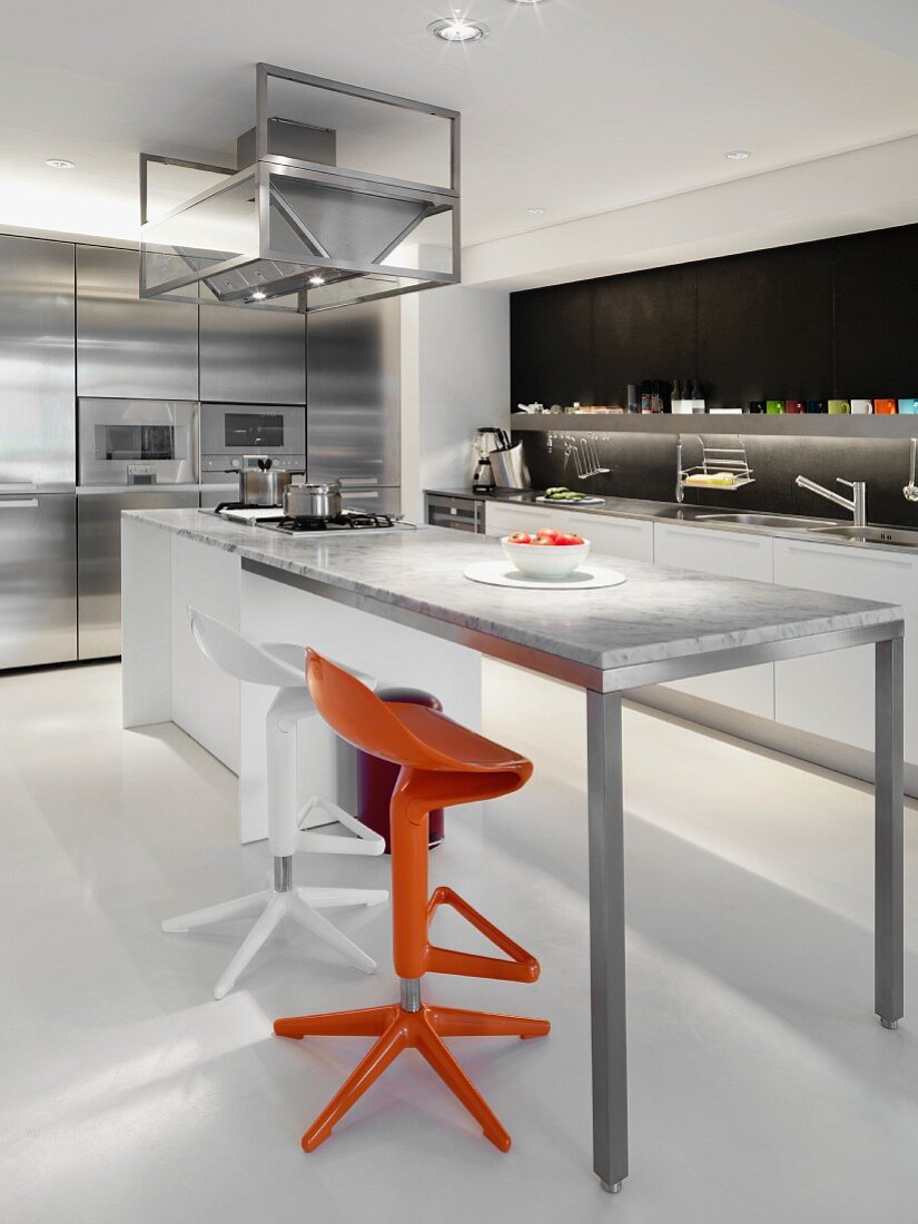 Modern Kitchen with orange and white bar stools