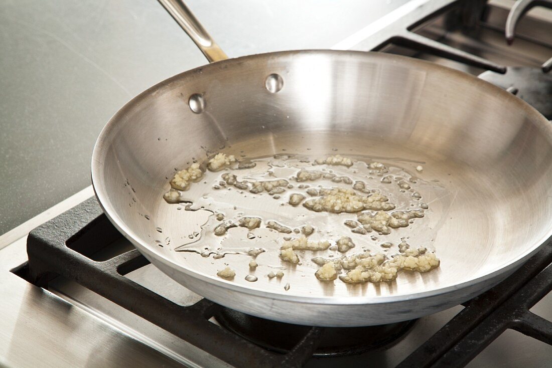 Sauteing Minced Garlic in a Skillet with Olive Oil