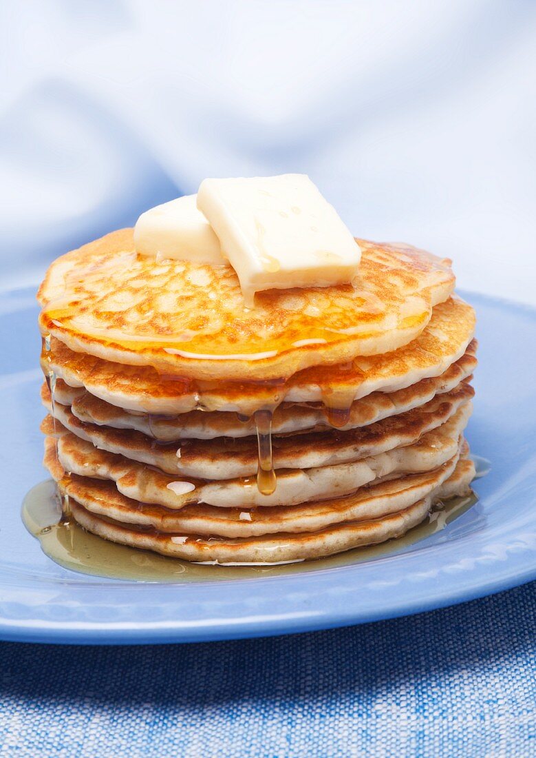 Pile of pancakes with maple syrup and butter