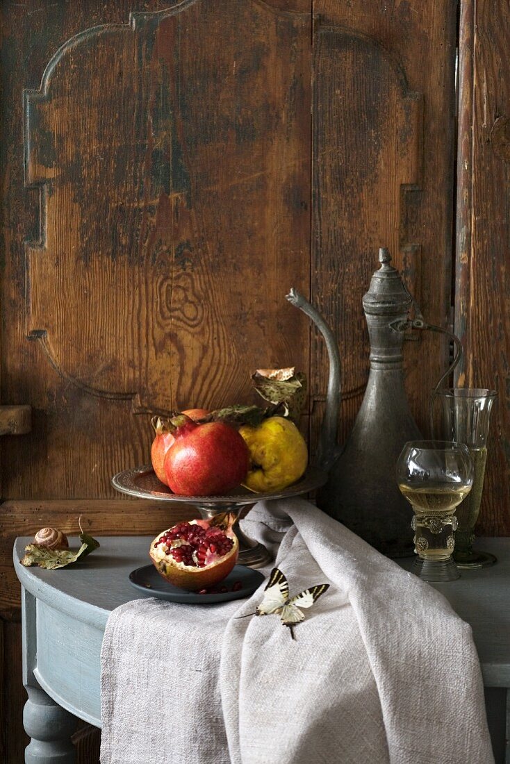 Autumn still life with pomegranates and a quince