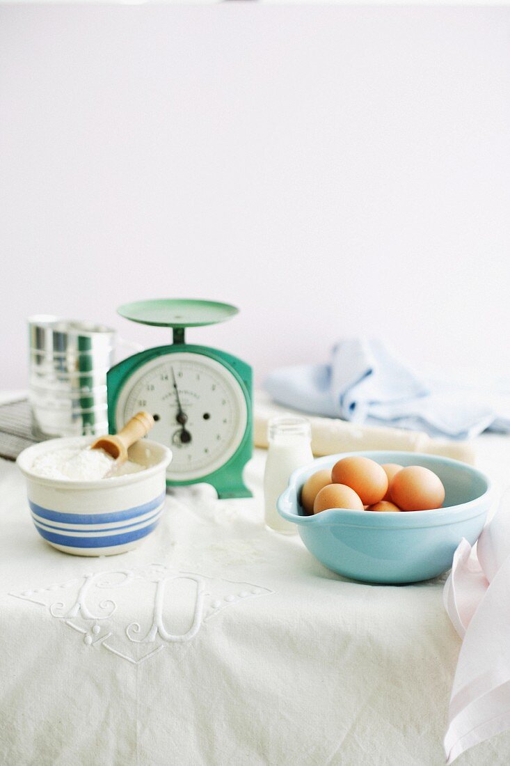 Eggs, flour, milk and a pair of kitchen scales