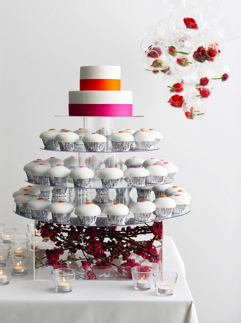 Display with frosted cupcakes and cake