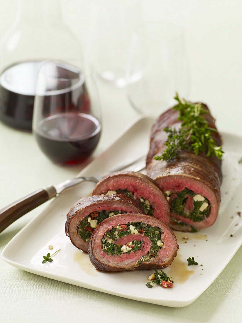 Partially Sliced Stuffed Rolled Beef on a Serving Platter