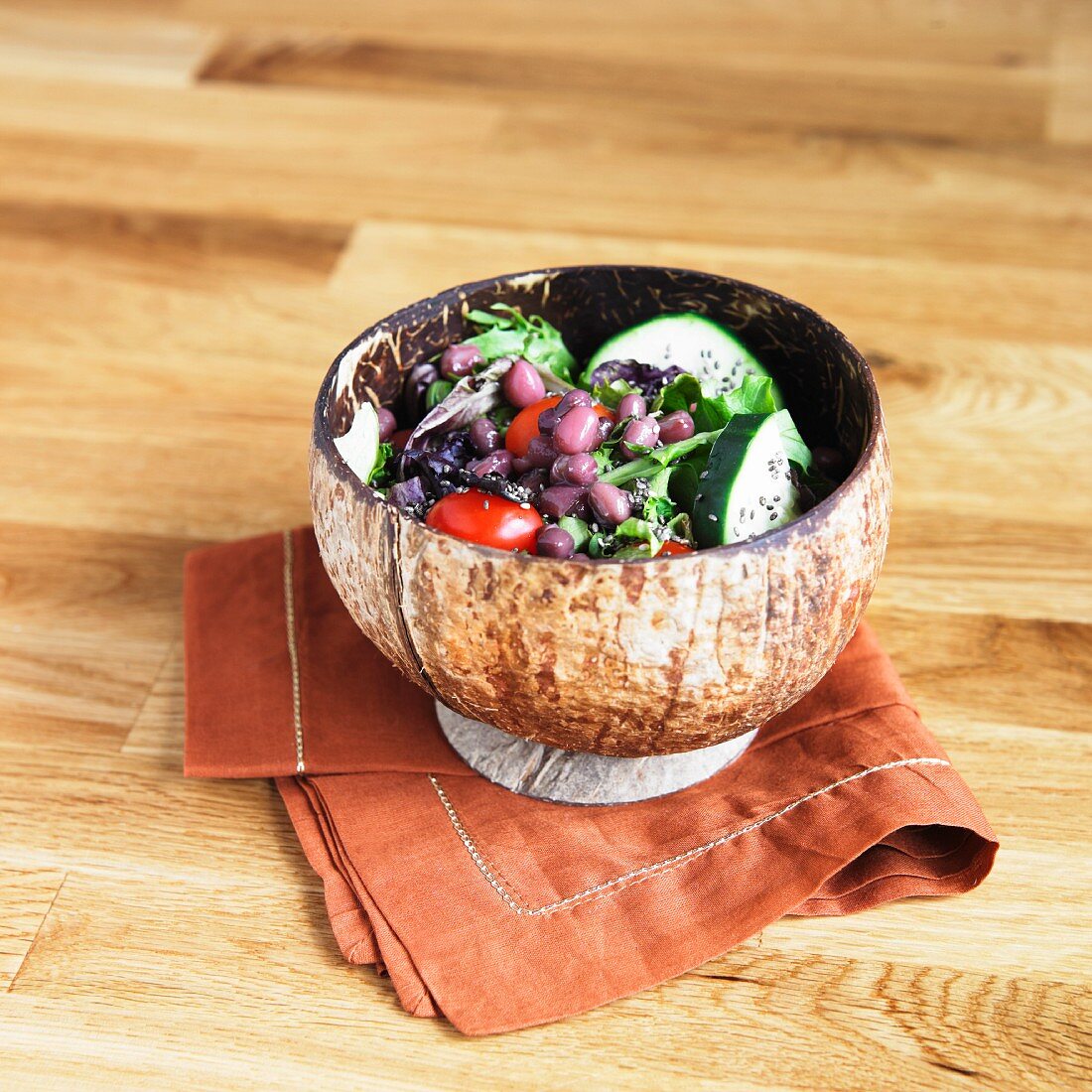 Salad with Chia Seed, Adzuki Beans, Tomatoes, Cucumber and Greens in a Small Bowl