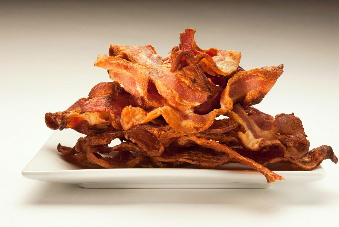 Crispy Bacon Strips Piled on a Dish