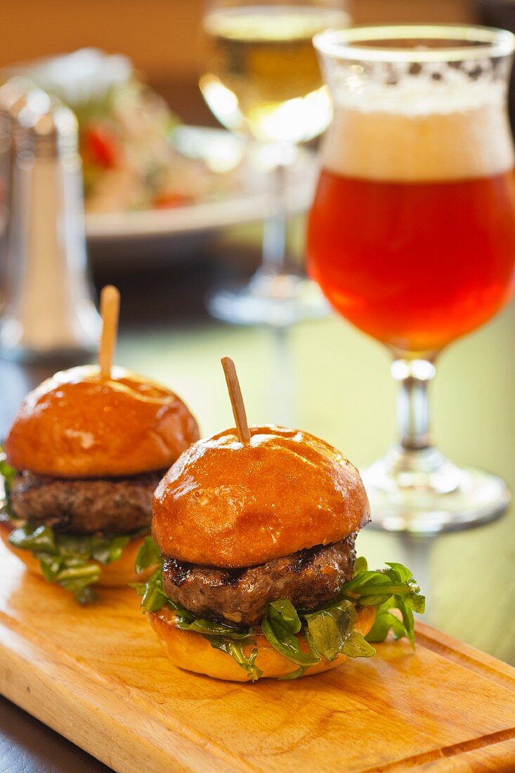 Two Slider Burgers with a Glass of Beer