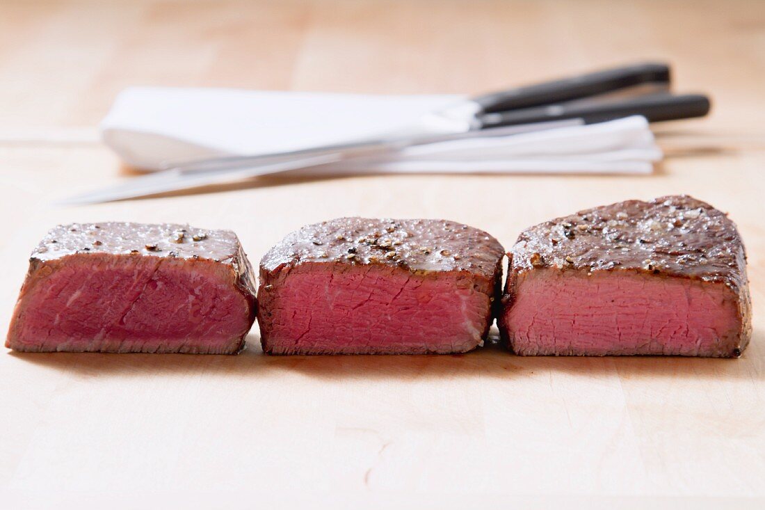 Fried fillet steaks with different levels of doneness