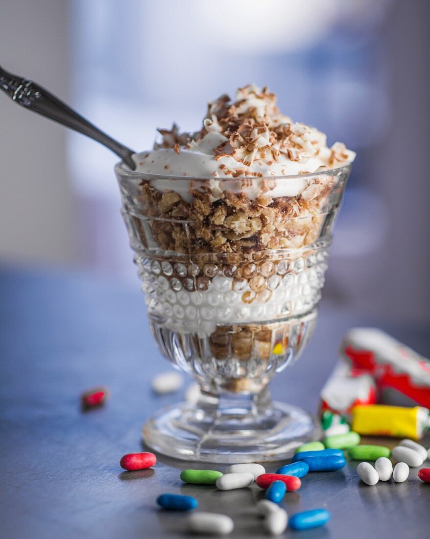 A layered dessert with chopped Kinder chocolate and yogurt cream