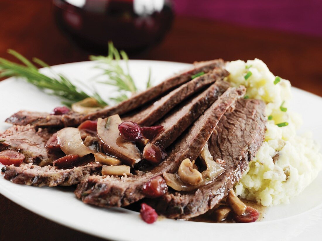 Sliced Brisket with Cranberries and Mushrooms; Served with Mashed Potatoes