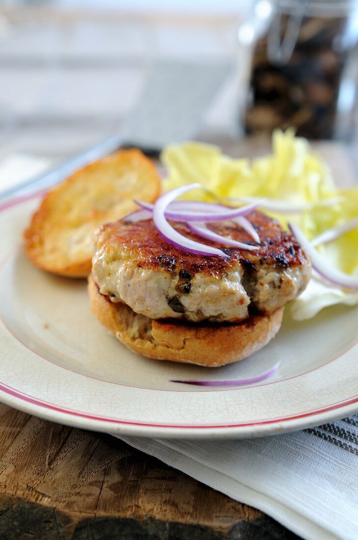 Turkey burger topped with red onions