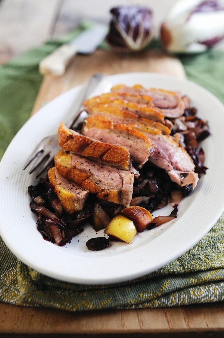 Pan fried duck breast on a bed of braised red cabbage and apple