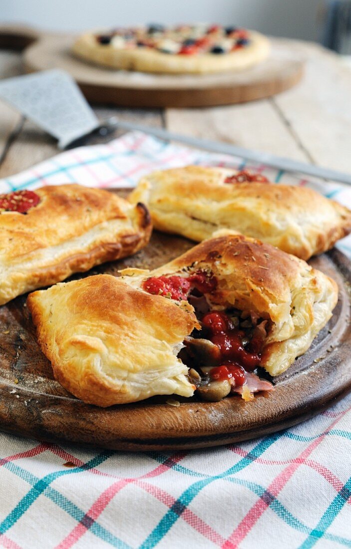 Puff pastry pockets filled with ham, tomato, mushrooms and mozzarella cheese