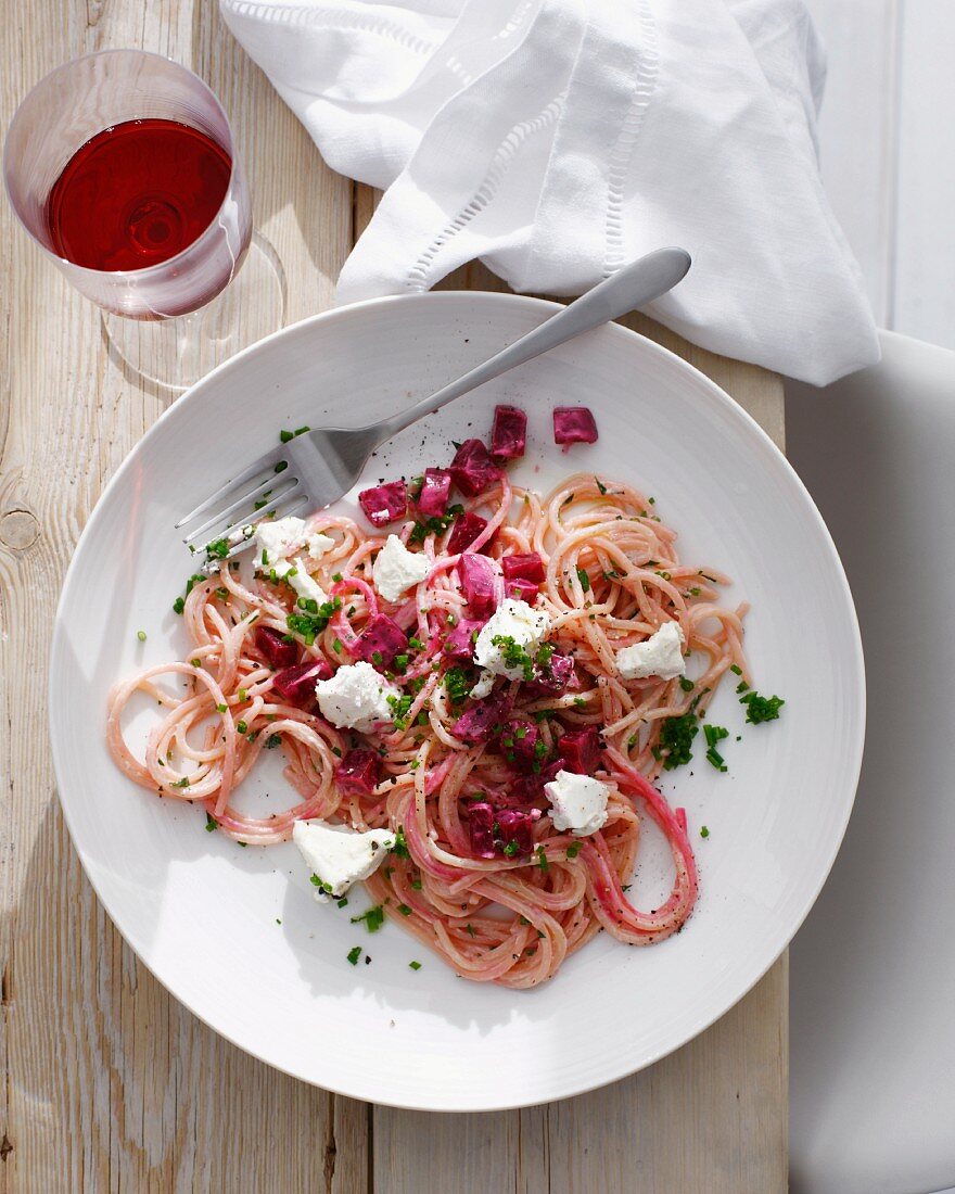 Plate of beetroot pasta with cheese