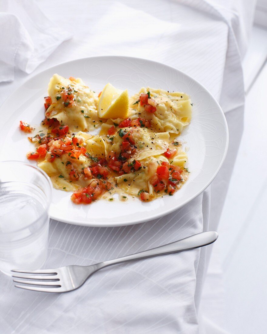 Plate of prawn ravioli with tomato sauce