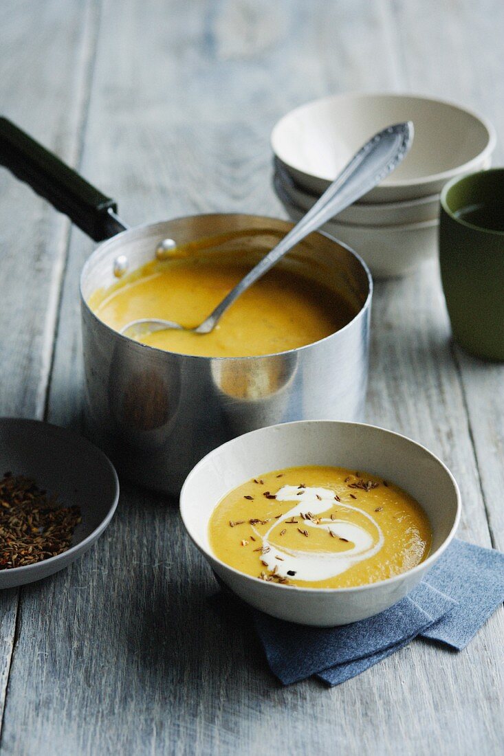 Bowls of carrot lentil soup on table