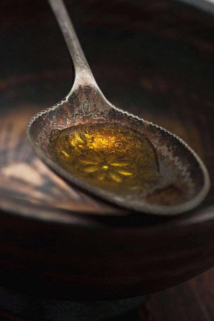 Close up of spoonful of olive oil