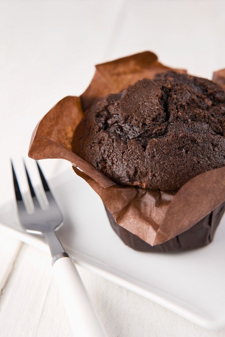 A chocolate muffin in a paper case