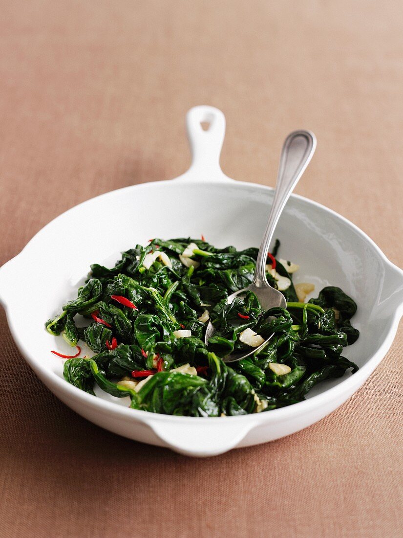 Dish of wilted greens with herbs