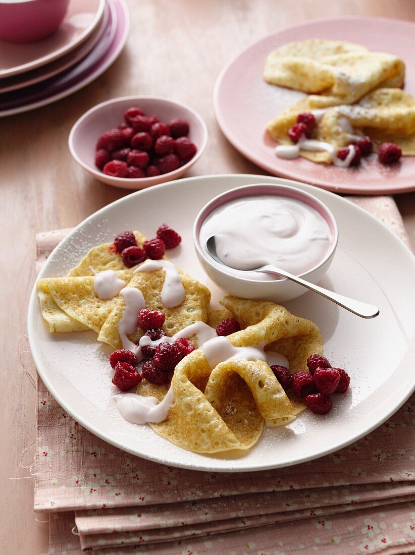 Plate of crepes with fruit and cream