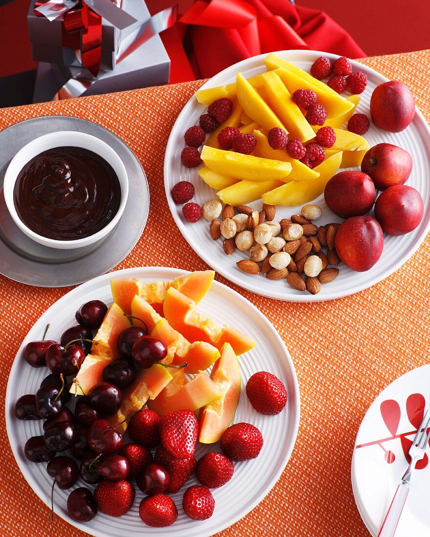 Plates of fresh fruit and nuts