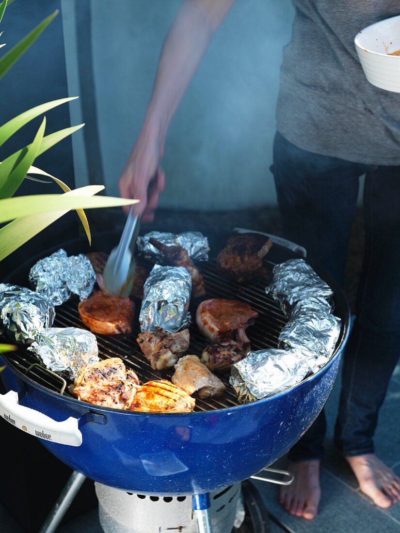 Pork chops being turned on a barbecue