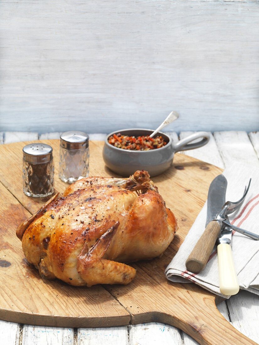 Roast chicken with tapenade on a chopping board