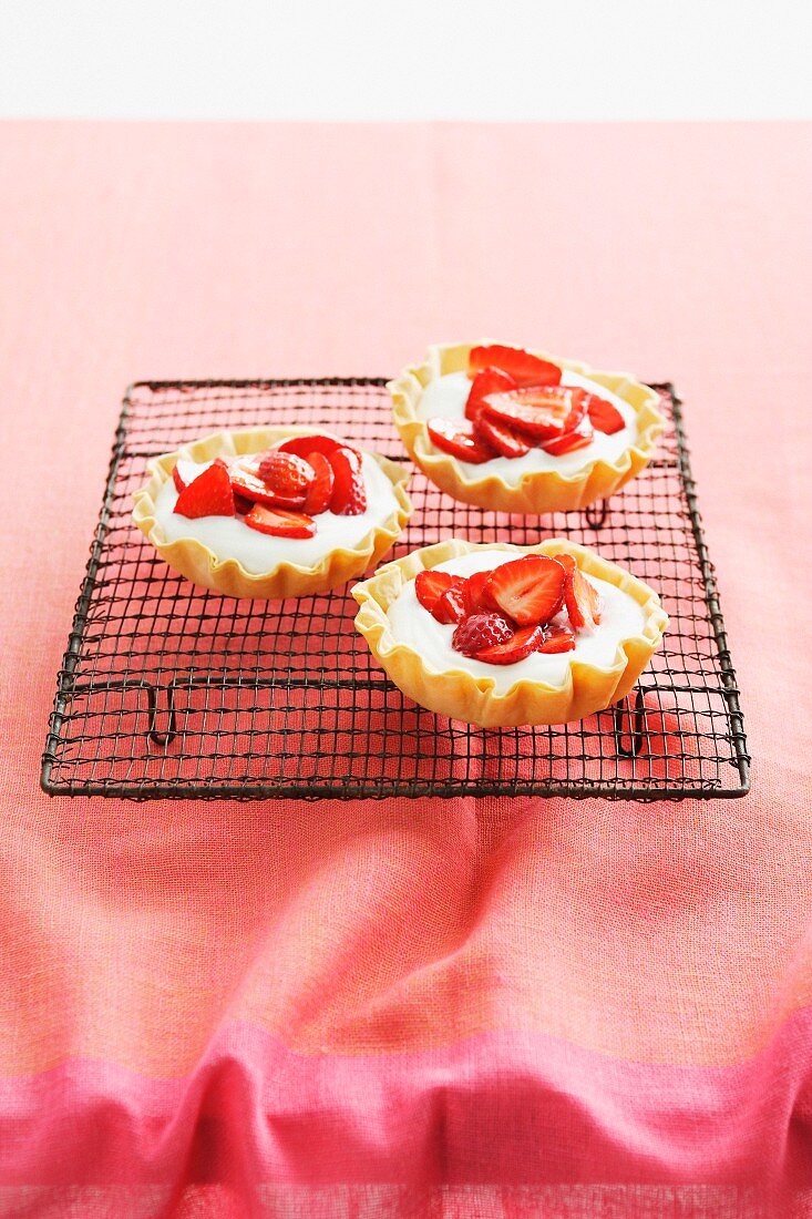 Strawberry tartlets on cooling rack