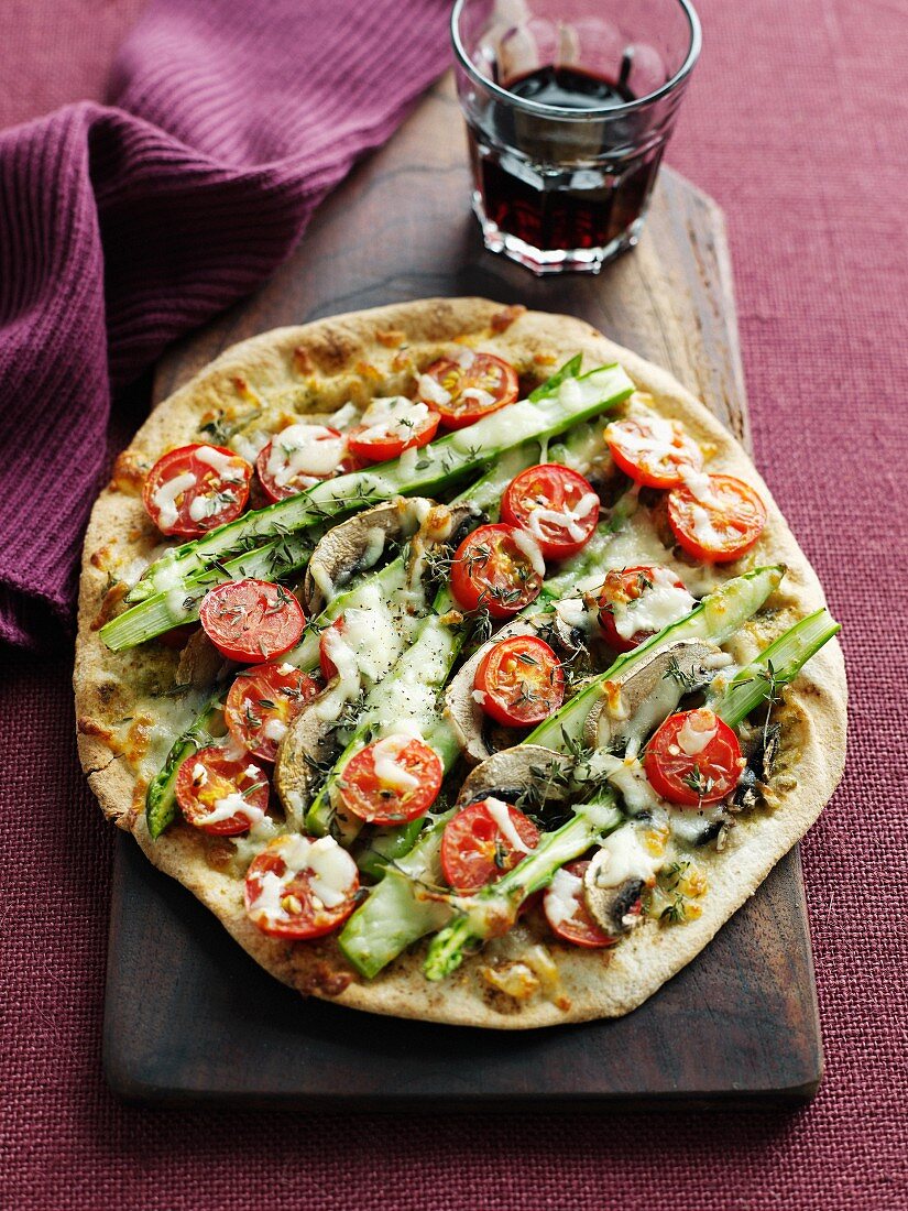 Plate of pizza with tomato and asparagus