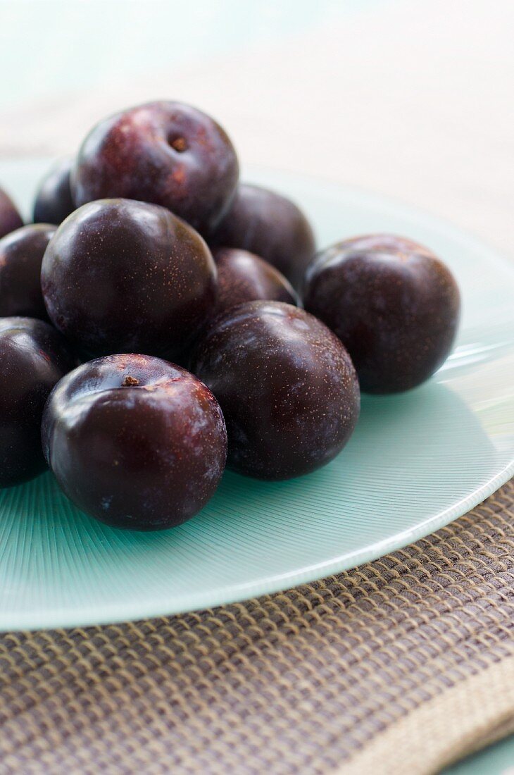 Fresh plums on plate