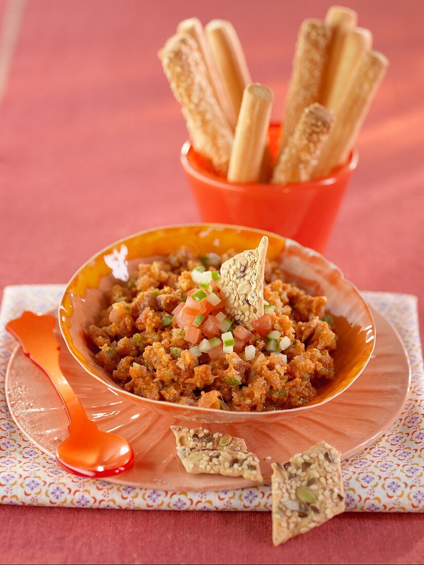Tomato dip with crackers and grissini