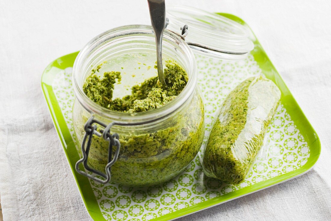 Pesto in a jar and wrapped in cling film