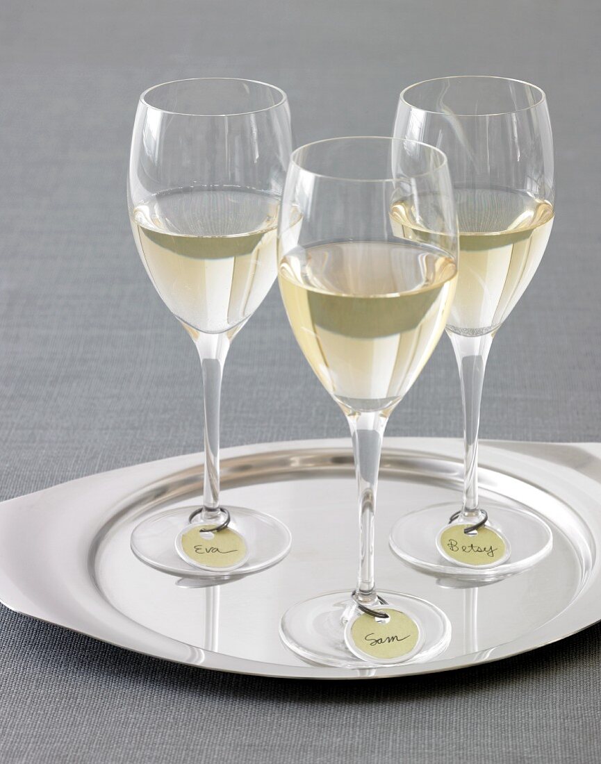 Three Glasses of White Wine with Name Tags on a Silver Tray