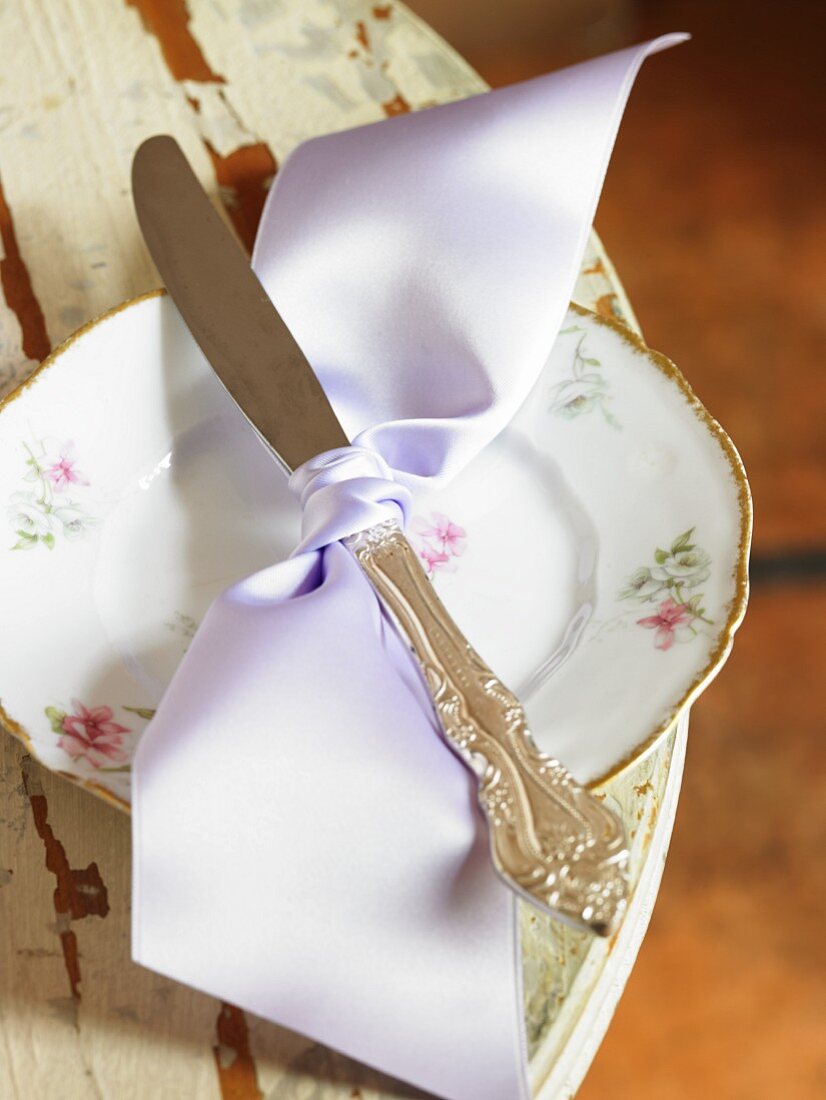 Knife Tied with a Lavender Ribbon on a Pretty Dessert Plate