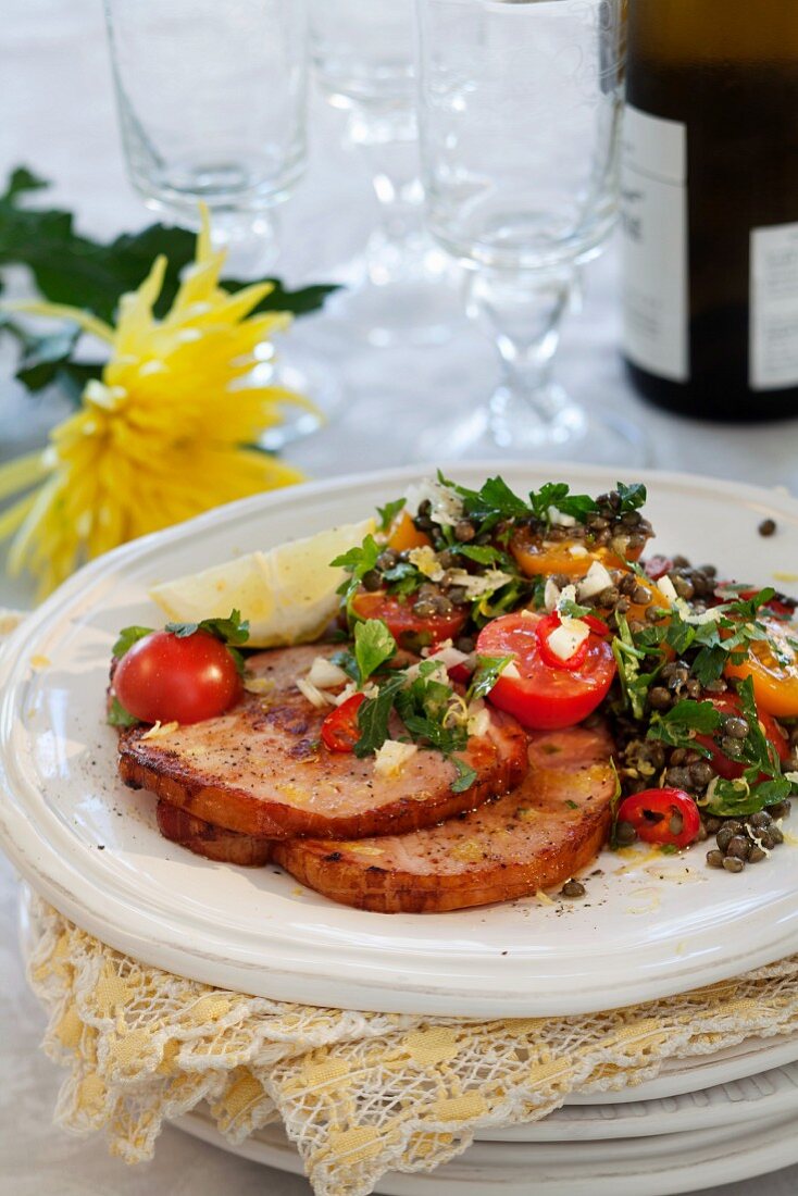 Smoked pork with a tomato and lentil salad