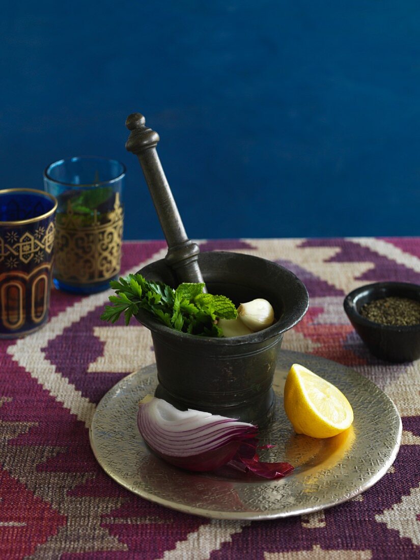 An arrangement of onions, garlic, herbs and lemon (Morocco)