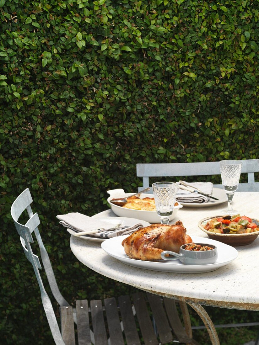 Roast chicken on a table in the garden