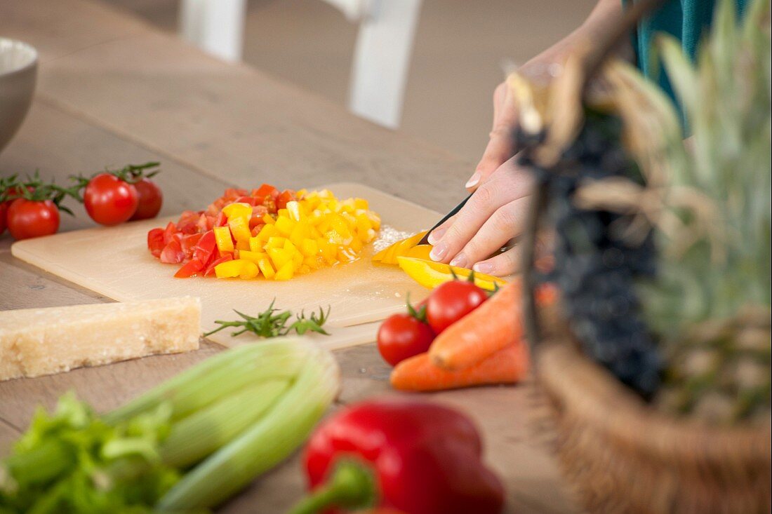 Close up of woman chopping peppers