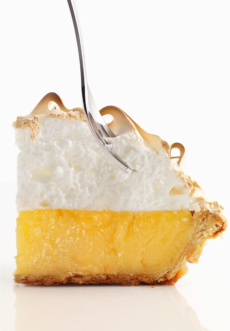 Lemon meringue pie with a fork