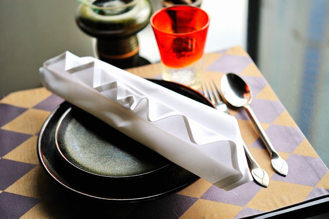 A place setting with an artistically folded napkin