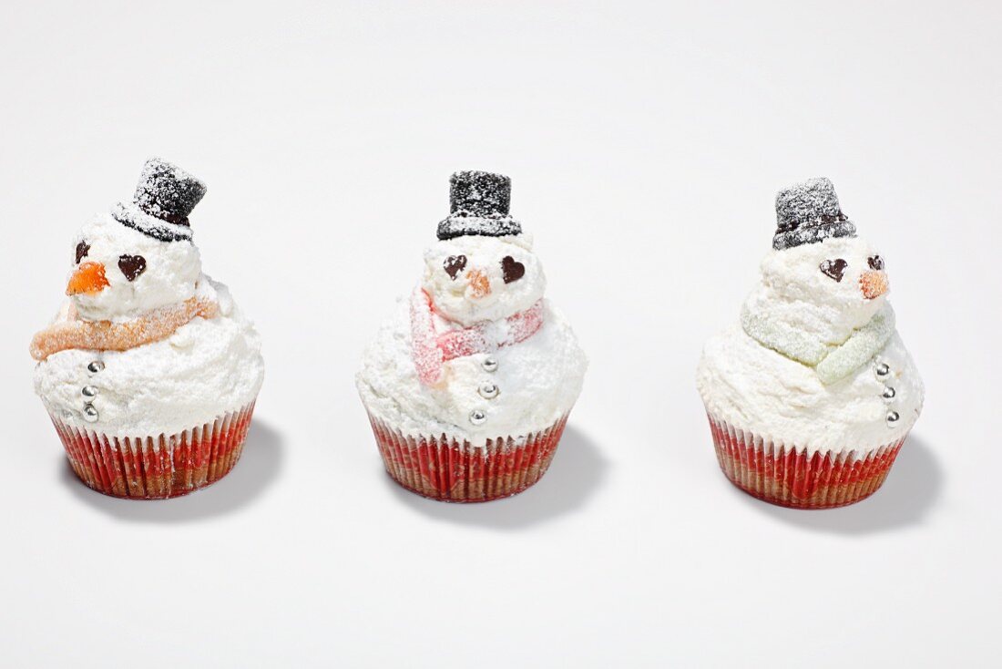 Snowman cupcakes on a white surface
