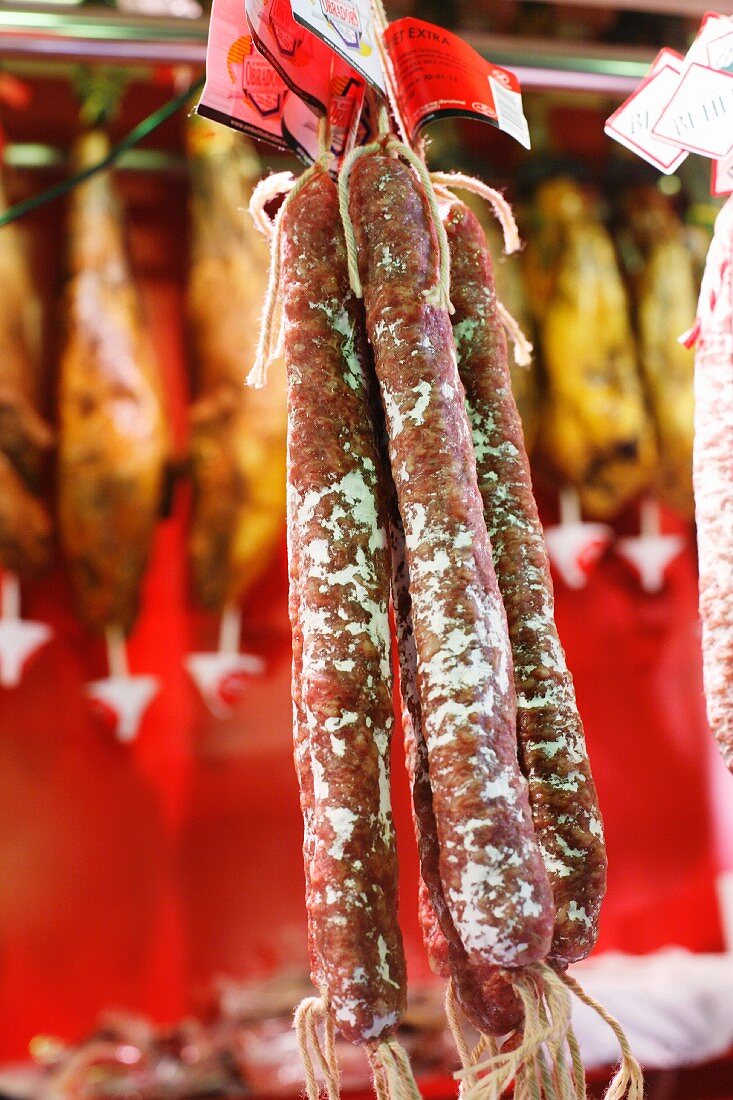 Spanish Dry Aged Sausages Hanging on Display at the La Boqueria Market in Barcelona, Spain