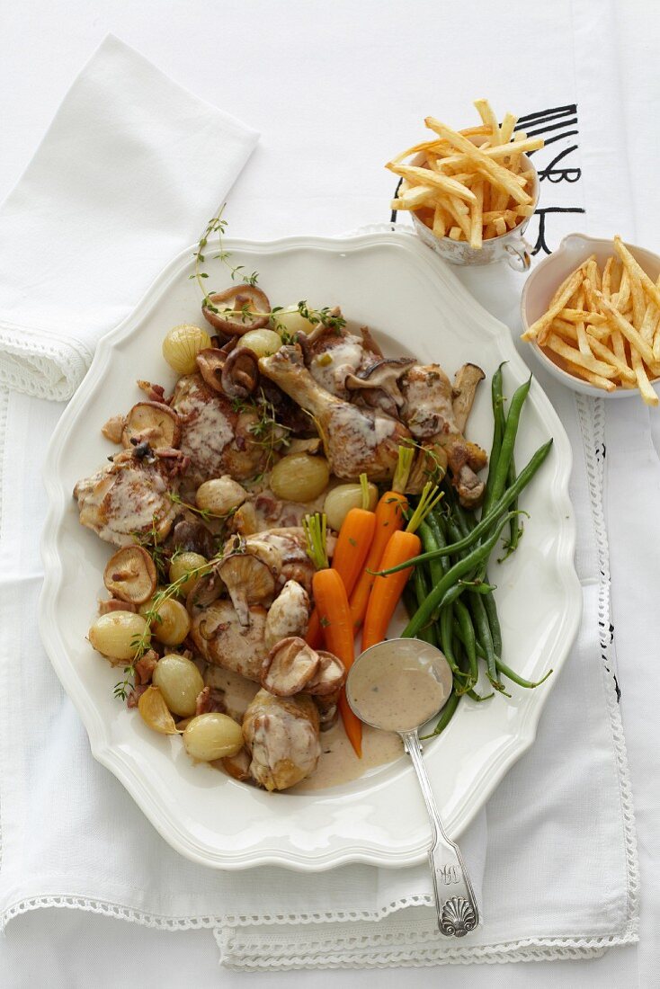 Chicken fricassee in a white wine sauce with vegetables and chips