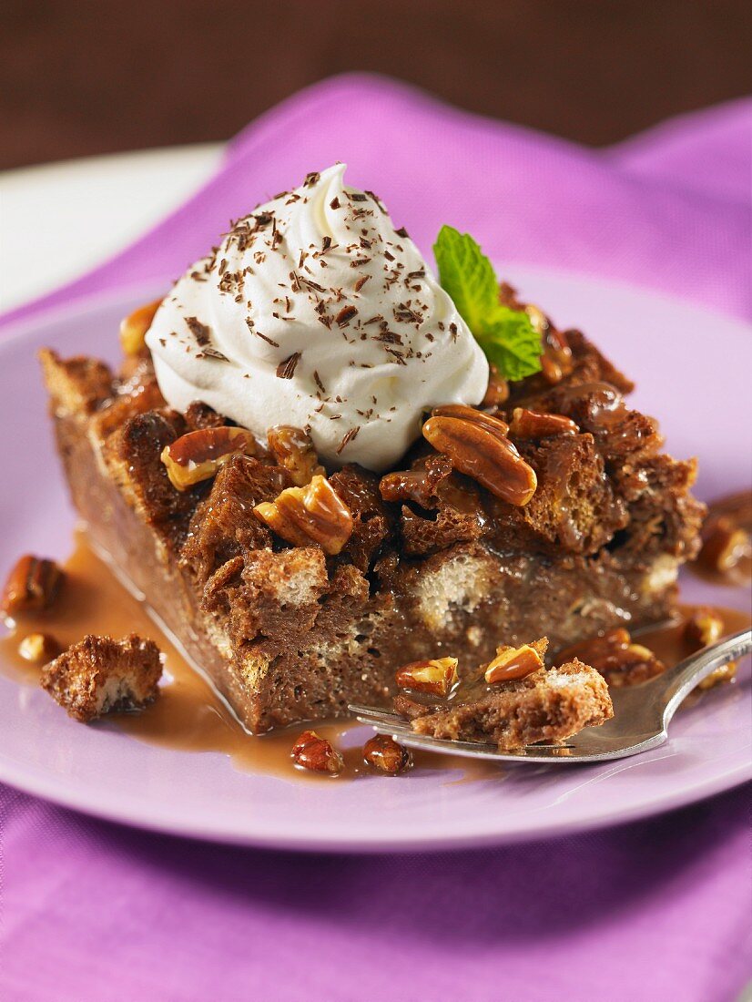 Chocolate bread pudding with pecan nuts and cream