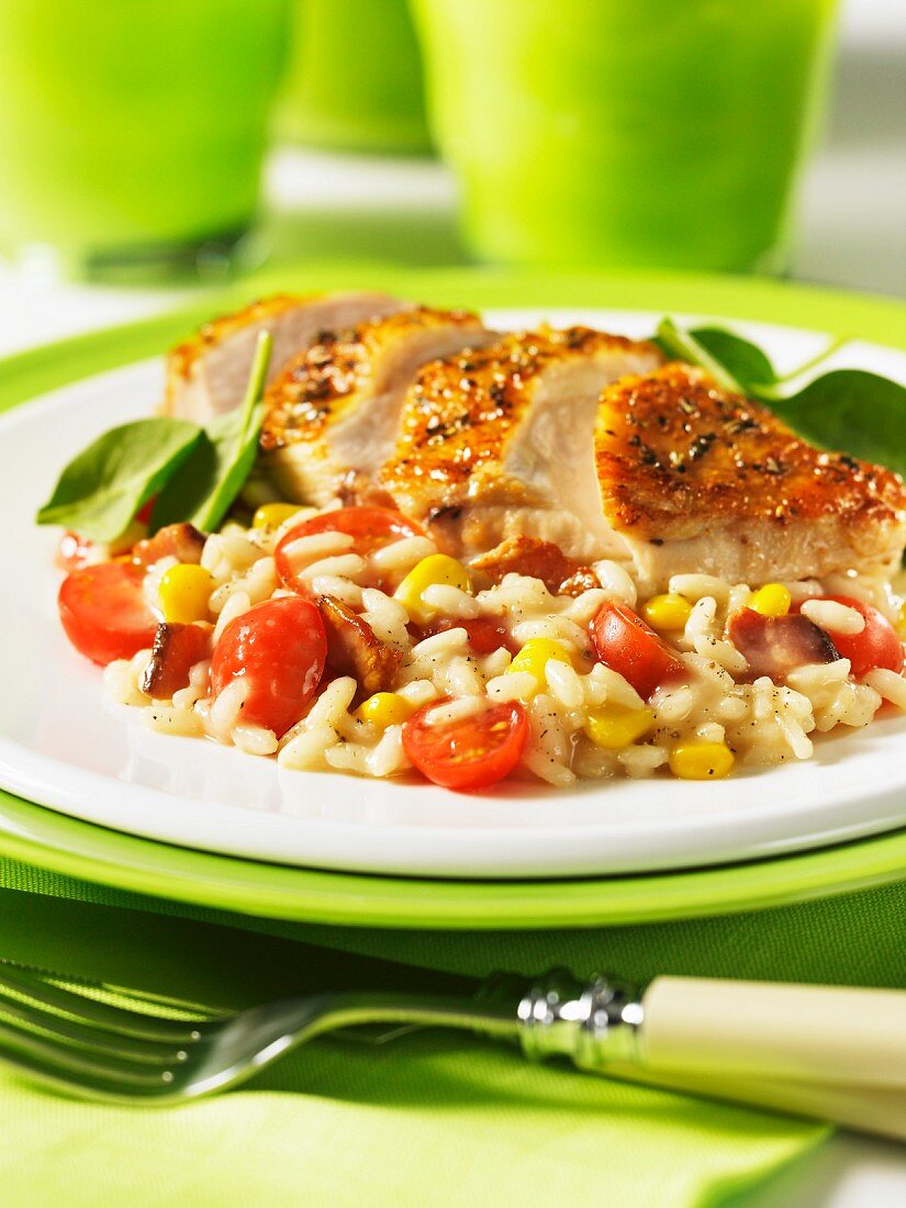 Fried chicken breast with a tomato, sweetcorn and bacon risotto