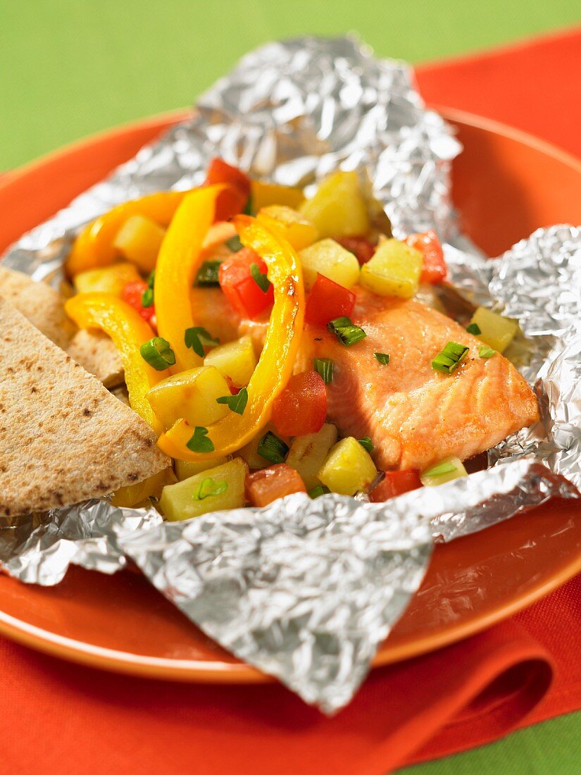 Salmon with peach salsa wrapped in aluminium foil