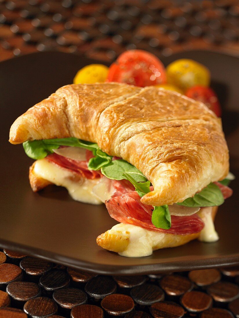 A croissant filled with salami and fontina cheese