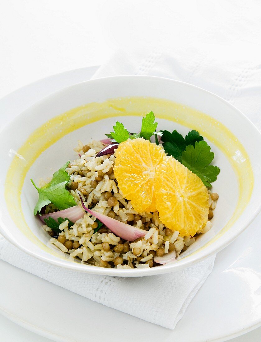 Rice salad with lentils, onions, parsley and oranges