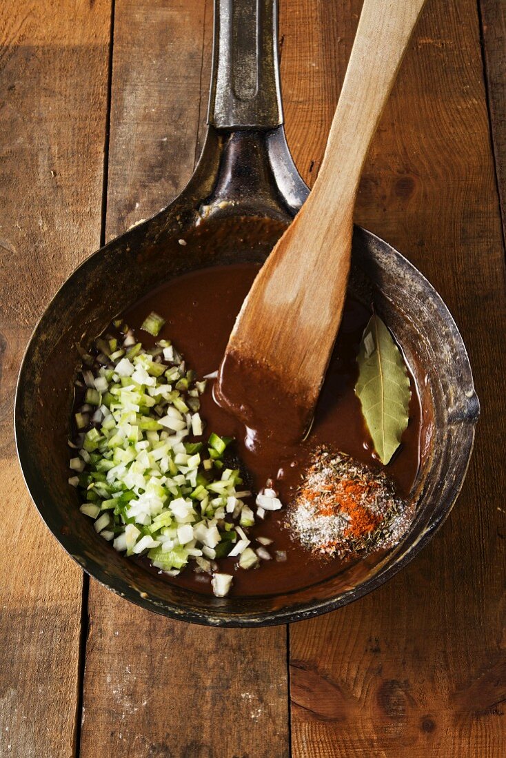 Cajun Roux in a Skillet with a Wooden Spoon